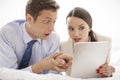 Shocked business couple using digital tablet in hotel Royalty Free Stock Photo