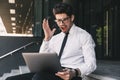 Shocked business man near business center using laptop computer. Royalty Free Stock Photo