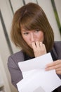 Shocked business woman reading letter