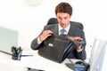 Shocked businessman in office looking in briefcase Royalty Free Stock Photo