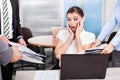 Shocked businesswoman looking at folders