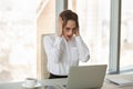 Shocked businesswoman looking at laptop screen