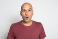 Shocked caucasian guy. Funny bald man isolated