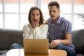 Shocked couple confused and scared watching horror movie on laptop Royalty Free Stock Photo