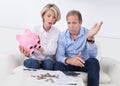 Shocked couple holding piggybank