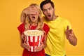 Shocked couple two friends guy girl in 3d glasses isolated on yellow background. People in cinema lifestyle concept. Watching