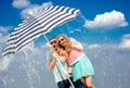 Shocked couple under the umbrella because of the stormy weather