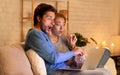 Shocked Couple Using Laptop Watching Movie Eating Popcorn At Home Royalty Free Stock Photo