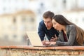 Shocked couple watching media on a laptop