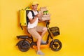 Shocked courier on electric scooter with thermo backpack delivering pizza and coffee to go, holding cell phone, looking at screen Royalty Free Stock Photo