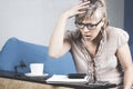 Shocked crazy woman checking expensive electricity and household bills sitting on sofa in the living room at home. finance interio Royalty Free Stock Photo