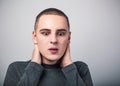 Shocked crying man with dropping tears on the face with headache holding the head and looking down. Closeup studio portrait on Royalty Free Stock Photo