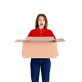 Shocked delivery girl is holding a big open parcel box isolated on white background