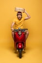Delivery man in yellow uniform riding
