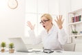 Shocked doctor with glasses sitting at the desktop Royalty Free Stock Photo
