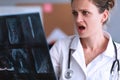 Shocked doctor looks at X-ray in clinic