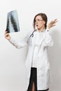 Shocked doctor woman looking X-ray of lungs, fluorography, roentgen isolated on white background. Female doctor in medical gown