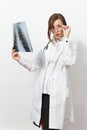 Shocked doctor woman looking X-ray of lungs, fluorography, roentgen isolated on white background. Female doctor in