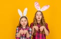 shocked easter children in bunny ears on yellow background