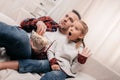 shocked father and daughter eating popcorn and watching tv together