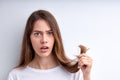 Shocked frustrated woman holding hair in hands, want to cut them out, having split ends Royalty Free Stock Photo