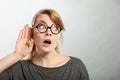 Shocked girl eavesdropping. Royalty Free Stock Photo