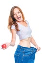 Shocked girl is happy with the result of an apple diet on a whit Royalty Free Stock Photo