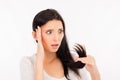 Shocked girl looking at her damaged ends of hair Royalty Free Stock Photo