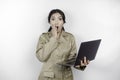 Shocked government worker woman holding her laptop with her mouth wide open. PNS wearing khaki uniform