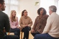 Shocked Group Consoling Man Speaking At Support Group Meeting For Mental Health Or Dependency Issues Royalty Free Stock Photo