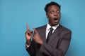 Shocked handsome young black business man pointing his hand up Royalty Free Stock Photo