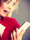 Shocked heartbroken woman looking at her phone Royalty Free Stock Photo