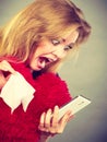 Shocked heartbroken woman looking at her phone Royalty Free Stock Photo