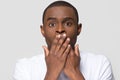 Shocked horrified african man covering mouth with hands feel scared Royalty Free Stock Photo