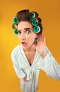 Shocked Housewife Holding Hand Near Ear Posing On Yellow Background Royalty Free Stock Photo