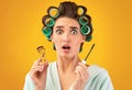 Shocked Housewife Holding Mascara And Eyelashes Curler, Studio Shot Royalty Free Stock Photo