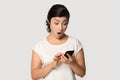 Shocked Indian girl using phone, reading unexpected news close up Royalty Free Stock Photo