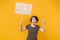 Shocked irritated protesting woman hold protest sign broadsheet placard on stick spreading hands isolated on yellow