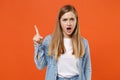 Shocked irritated young woman girl in casual denim clothes posing isolated on orange background studio portrait. People Royalty Free Stock Photo