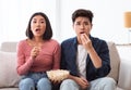 Shocked Korean Couple Watching TV Movie Sitting In Living Room Royalty Free Stock Photo