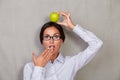 Shocked lady with apple on head and open mouth