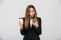 Shocked lady chat in smartphone and holding cup of coffee isolated