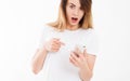 Shocked look at phone, cropped portrait surprised young woman looking at smartphone seeing bad news or photos with stunned emotion Royalty Free Stock Photo