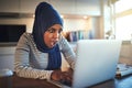 Shocked looking Arabic female entrepreneur working online at hom Royalty Free Stock Photo