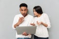 Shocked loving couple chatting by laptop computer Royalty Free Stock Photo