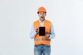 Shocked male engineer showing tablet screen, looks with opened mouth as remembers about important meeting. Male in Royalty Free Stock Photo