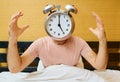 Shocked man with alarm clock instead of head has overslept. Lateness concept Royalty Free Stock Photo