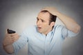 Shocked man feeling head, surprised he is losing hair Royalty Free Stock Photo