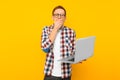 Shocked man with laptop, on yellow background, man shopping online Royalty Free Stock Photo