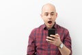 Shocked man looking at his smartphone